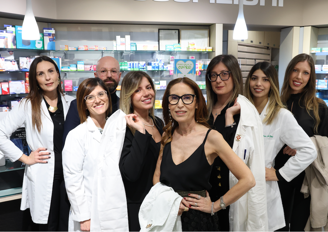 Group of people in the Aliotta pharmacy, with some wearing white lab coats.